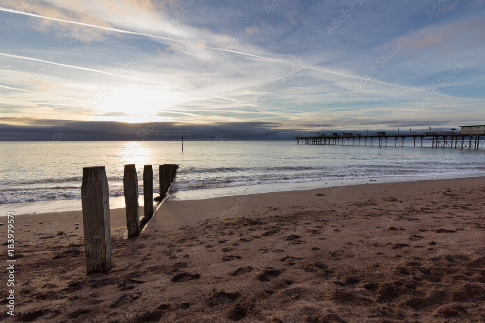 Sunrise on Teignmouth beach Devon, England with pier in the background