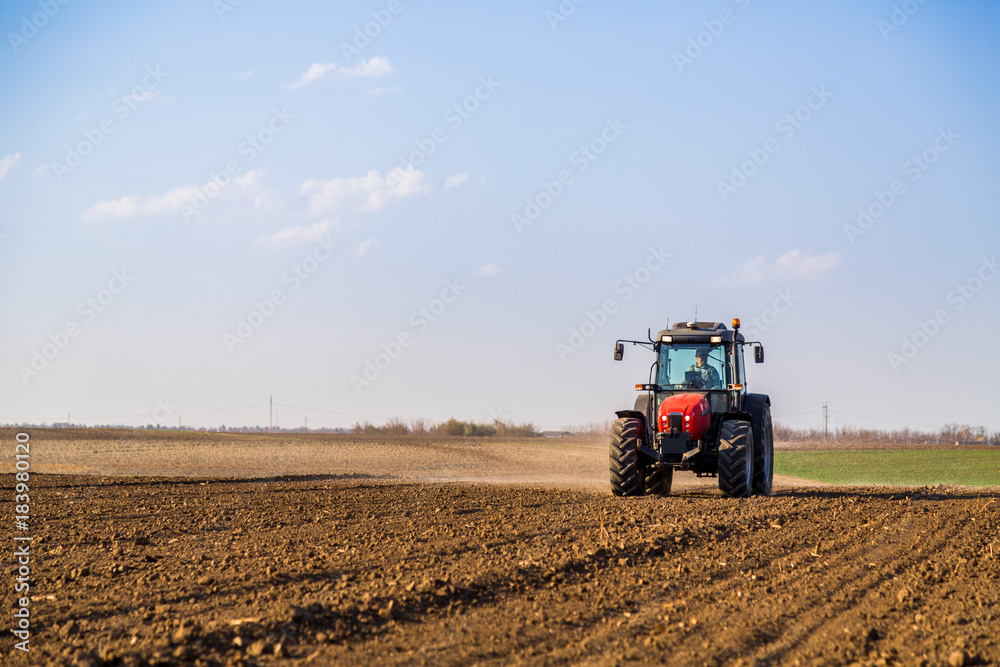 Farmer fertilizing arable land with nitrogen, phosphorus, potassium fertilizer Farmer fertilizing arable land with nitrogen, phosphorus, potassium fertilizer