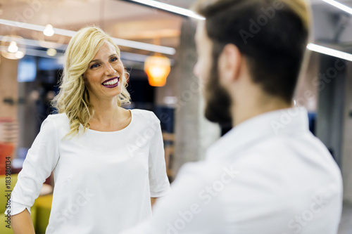 Beautiful saleswoman talking to customer