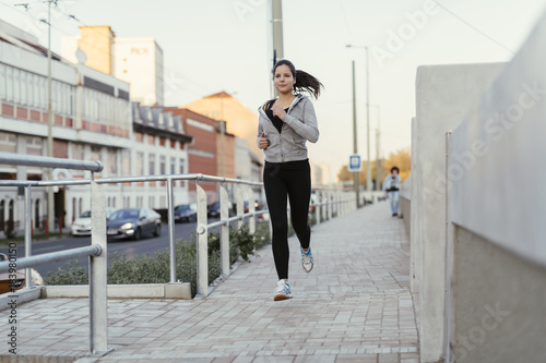 Beautiful female jogging in city
