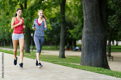 Two women jogging in park