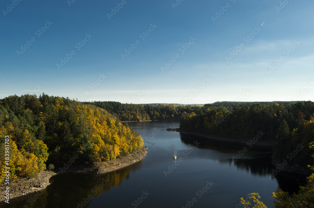 Autumn landscape of the river between forests