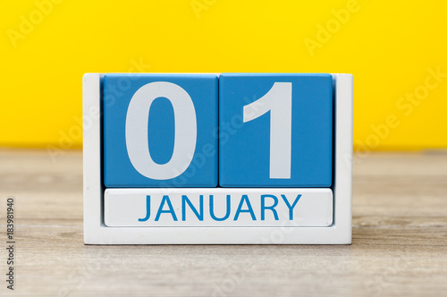 January 1st. Day 1 of january month, calendar on yellow background. Happy New year, Winter time