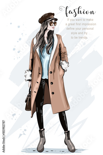 Fashion model posing. Stylish beautiful woman in coat and cap. Hand drawn fashion woman. Sketch. Vector illustration.