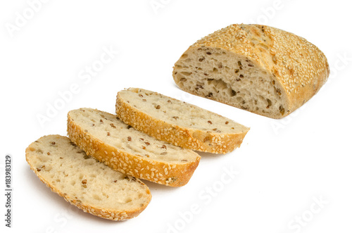 Sesame bread with different seeds and sliced isolated on white background