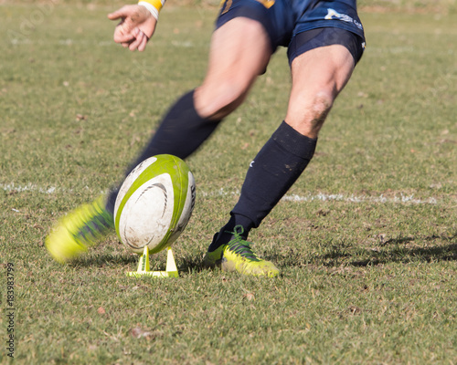 Fotografie Legs of rugby player kicking ball