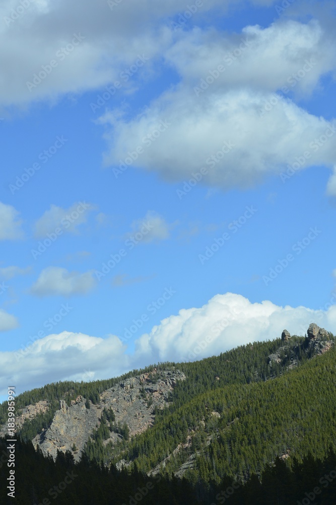 Fototapeta premium Puffy clouds over the Rockies