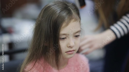Wallpaper Mural Hair stylist make curls on young baby girl hair using electric curler, slow mo, High Angle. Torontodigital.ca