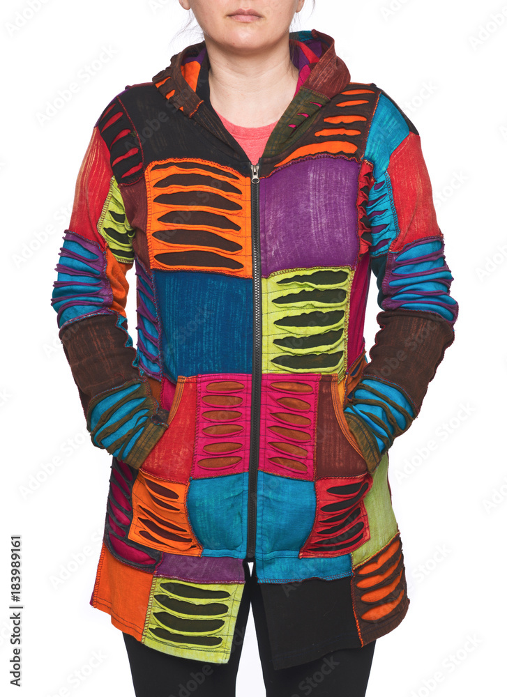 Young woman wearing coat of many colors hooded long patchwork jacket  isolated on white background Stock-Foto | Adobe Stock