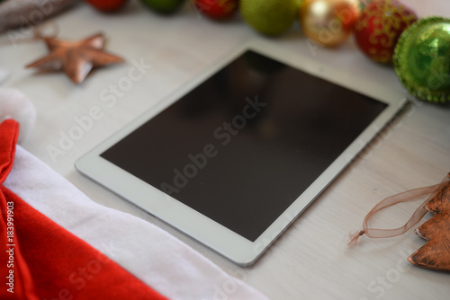Close up on using digital tablet PC for Christmas or happy New Year season abstract copy space background. Modern use of mobility communication networking technology and festive decoration abstraction