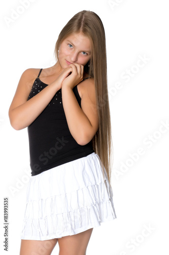 A teenage girl in a short white skirt and a black T-shirt. © lotosfoto