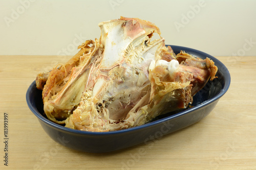 Turkey bones left over from Thanksgiving or Christmas meal in blue bowl on table