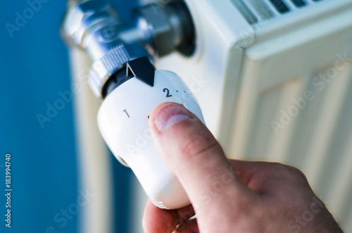 One hand adjust thermostat valve close up photo