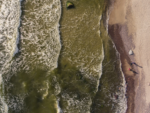 Aerial view over a Baltic Sea shore line in Karkle near Klaipeda city, Lithuania. During sunny summer day. photo