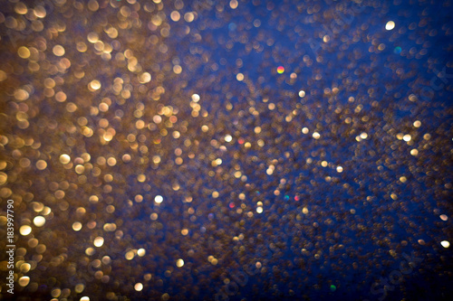 Golden and silver glitter backgound with bokeh abstract effect