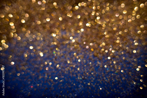 Golden and silver glitter backgound with bokeh abstract effect