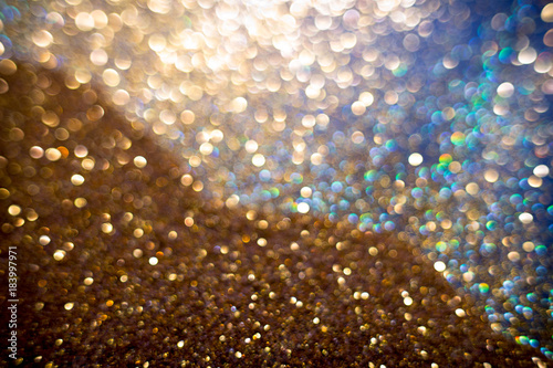 Golden and silver glitter backgound with bokeh abstract effect