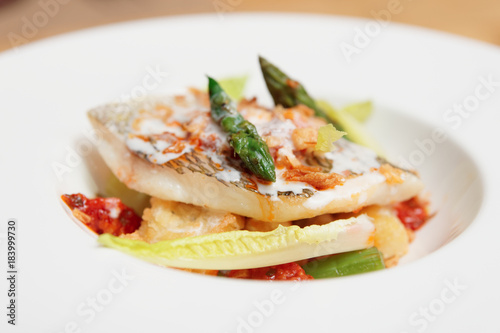 Grilled fish with asparagus in plate