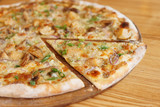 Pizza with porcini mushrooms with cut segment