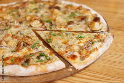 Pizza with porcini mushrooms with cut segment