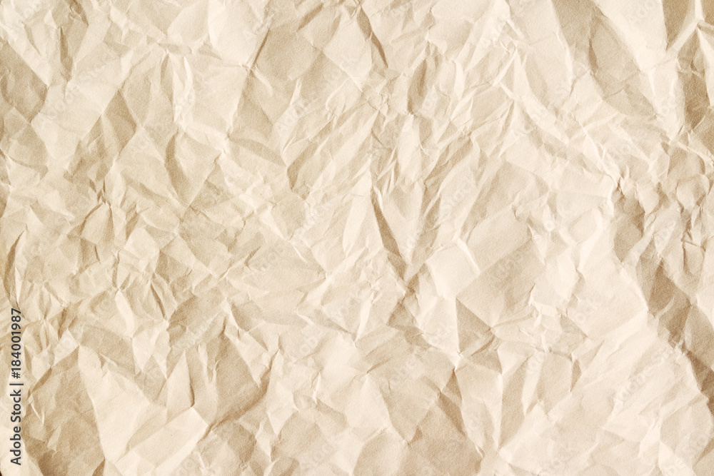Obraz premium Old crumpled parchment texture. Beige aged paper sheet background.