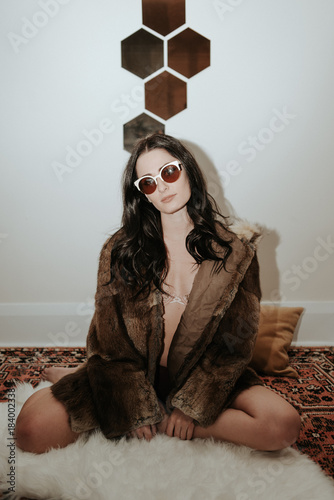 Fashion young woman wearing fur jacket 70s glam New Years Party photo