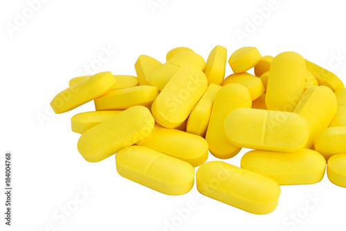  yellow pills and white isolated background