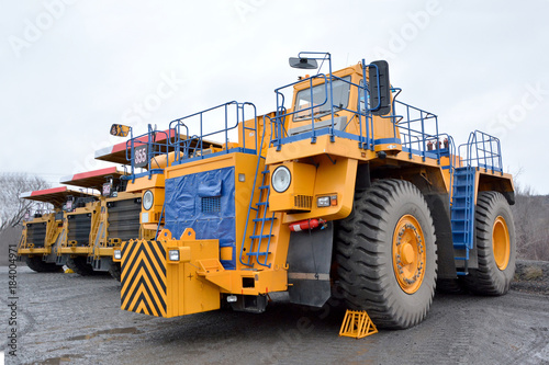 Tractor and three quarry dump trucks