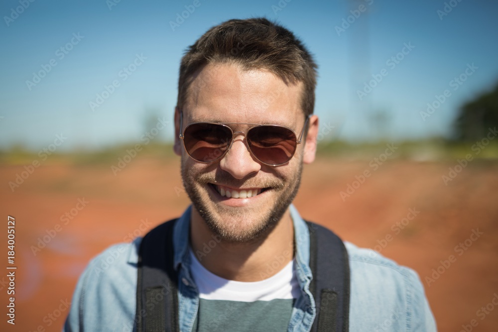 Man in sunglasses standing with his backpack Man in sunglasses standing with his backpack