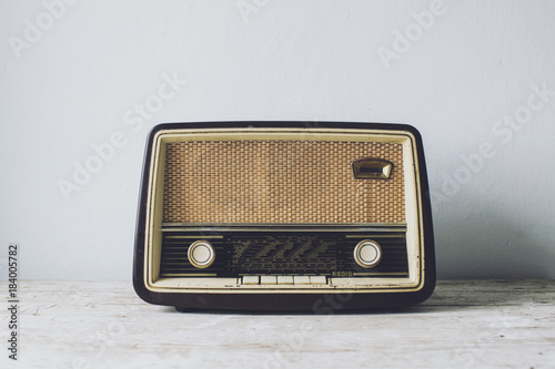 Antique radio on vintage table photo
