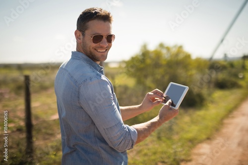 Man using digital tablet on a sunny day