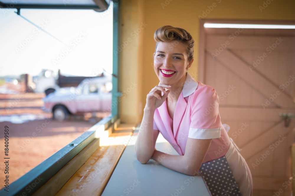 Waitress standing at counter in restaurant Waitress standing at counter in restaurant