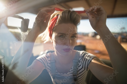 Woman wearing a headband in a car