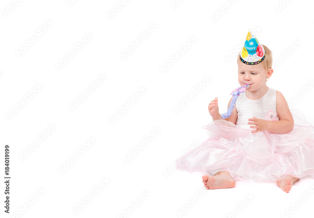The baby girl in a pink dress on the white background
