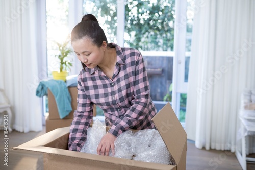 Woman unpacking boxes in new home