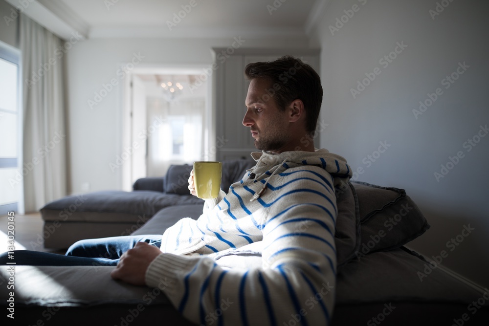 Man having coffee in the living room