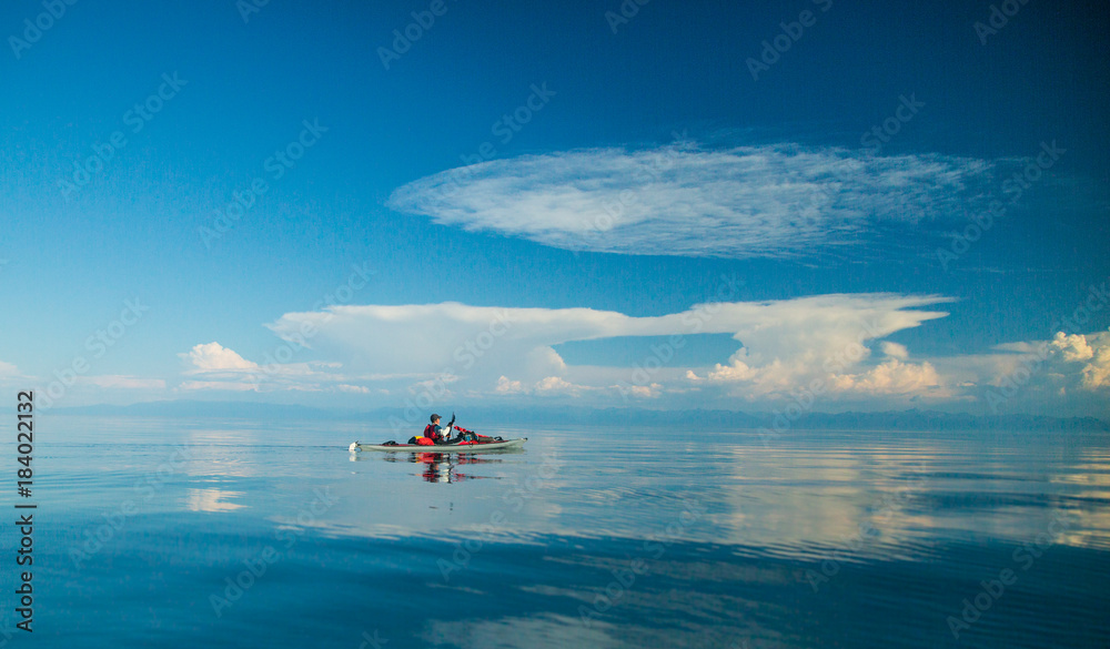 Mеn kayaking on Lake Baikal. Landscape. Siberia. Mеn kayaking on Lake Baikal. Landscape. Siberia.