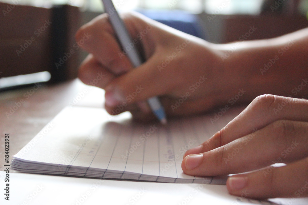 Fototapeta premium Student hand writing with a pen. 