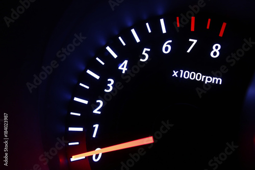 A tachometer gauge inside a car's dashboard photo