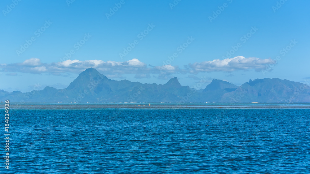 Tahiti in french Polynesia, beautiful panorama of the mountains from the lagoon, with the coral reef 

