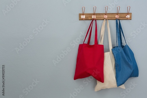 Various handbags hanging on hook