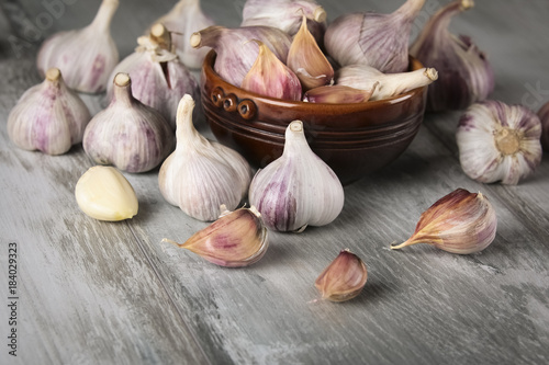 Close-up garlic bulbs and garlic cloves on wooden background