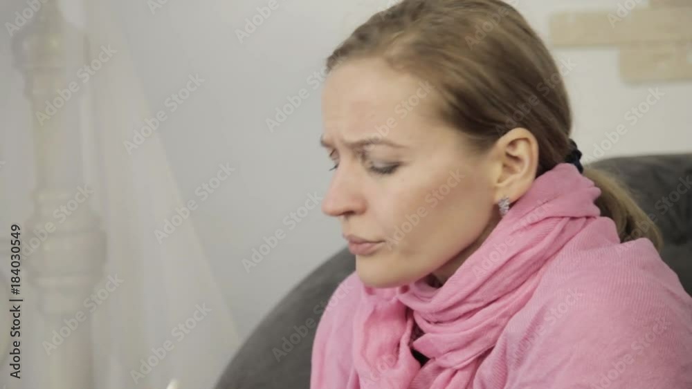 sick woman wipes his nose using a napkin and sneezes loudly sick woman wipes his nose using a napkin and sneezes loudly