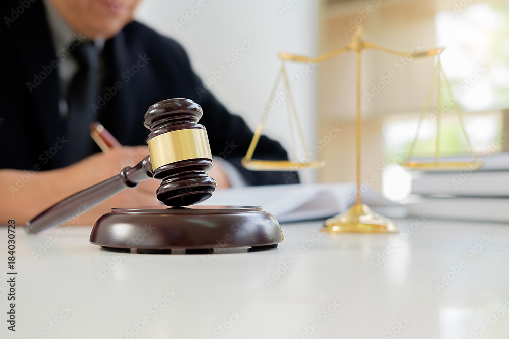 Judge gavel with Justice lawyers having team meeting at law firm in background. Concepts of law. Judge gavel with Justice lawyers having team meeting at law firm in background. Concepts of law.