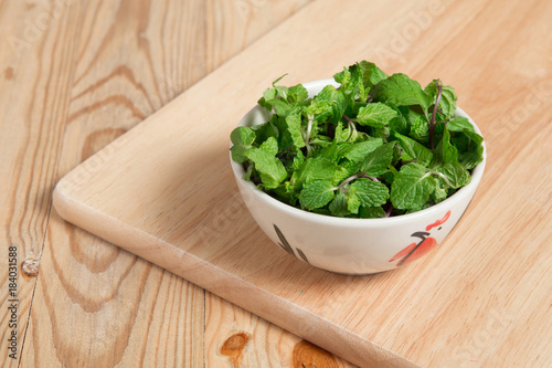 bowl of peppermint on a wood block