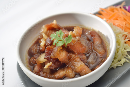 Pork sweet stewed in the sweet brown gravy, Chinese-Thai cuisine on grey background