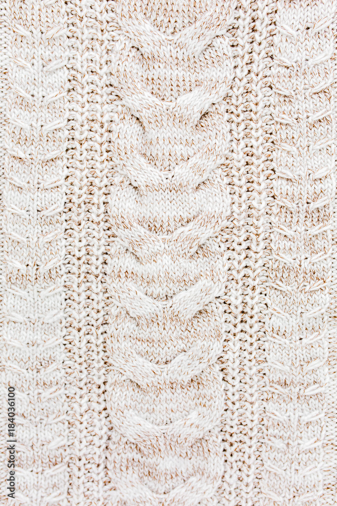 Beige knitted wool texture pattern.