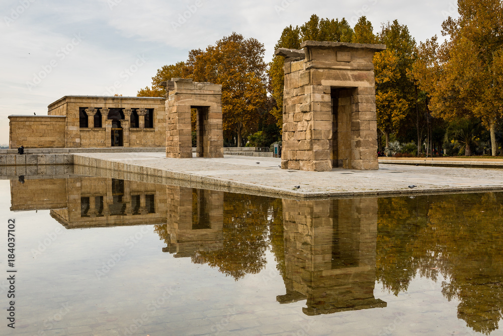 The temple of Debod is visited by tourists on a cloudy day