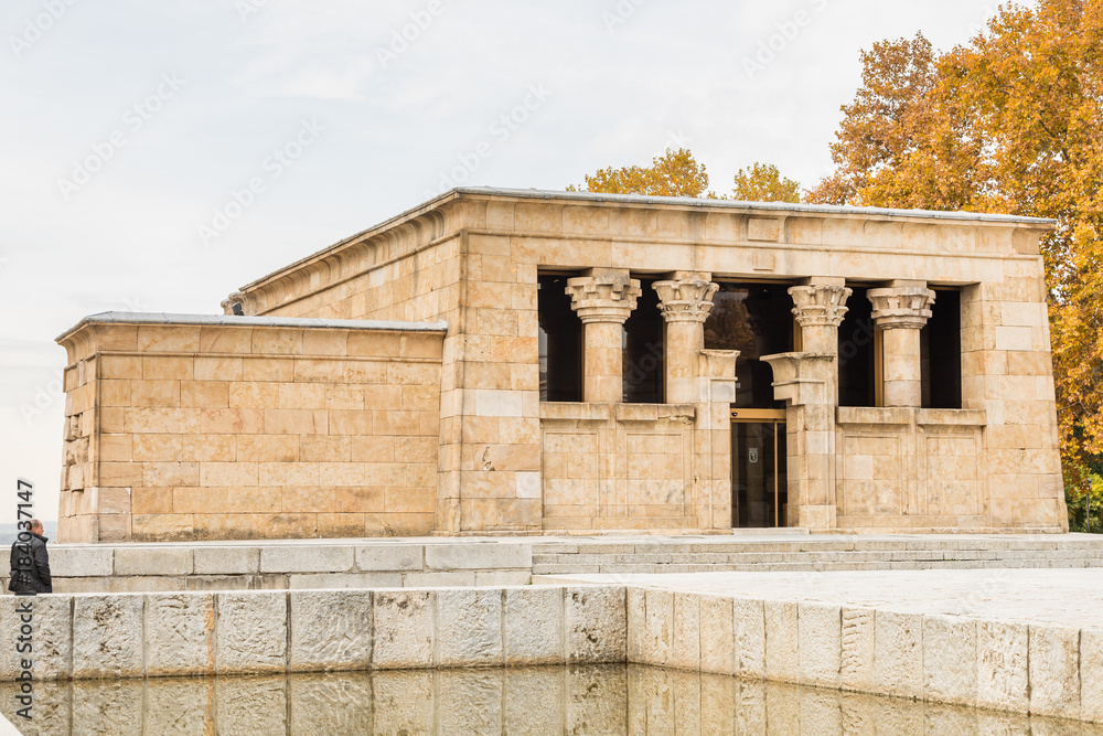 The temple of Debod is visited by tourists on a cloudy day