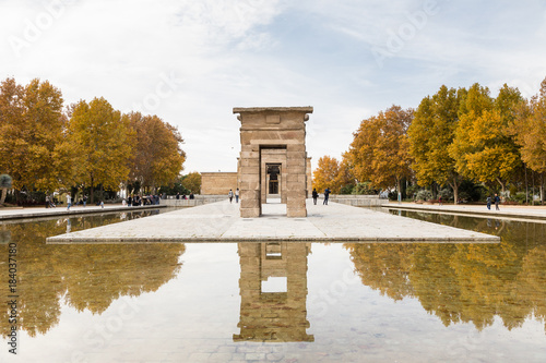 The temple of Debod is visited by tourists on a cloudy day